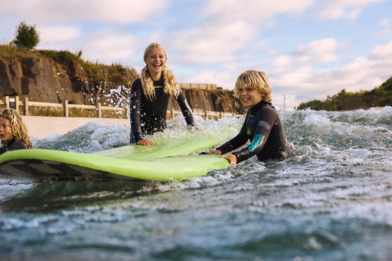 Children learning to surf